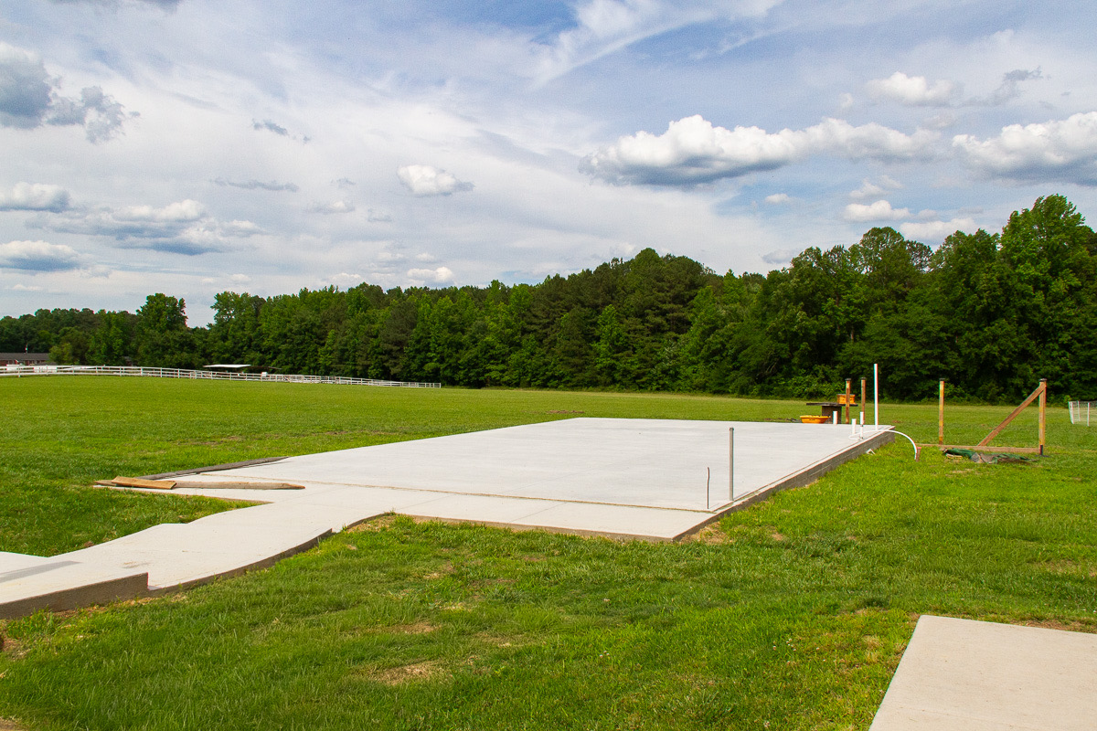 The poured foundation for Dennita's second schoolhouse, beside the first building